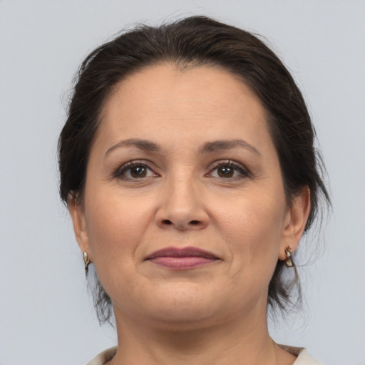 Joyful white adult female with medium  brown hair and brown eyes