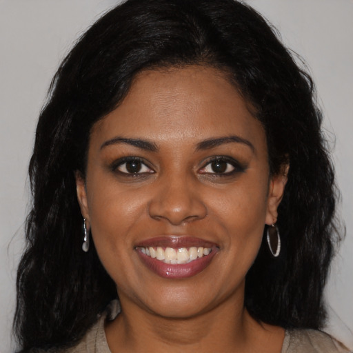 Joyful black young-adult female with medium  black hair and brown eyes