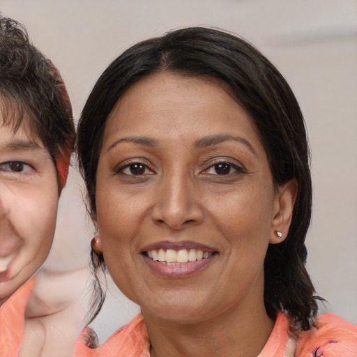 Joyful white adult female with medium  brown hair and brown eyes