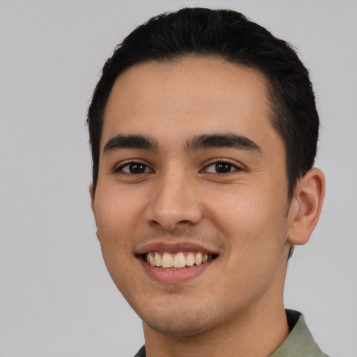 Joyful latino young-adult male with short  black hair and brown eyes