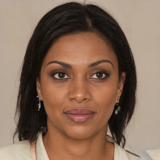 Joyful black young-adult female with medium  brown hair and brown eyes