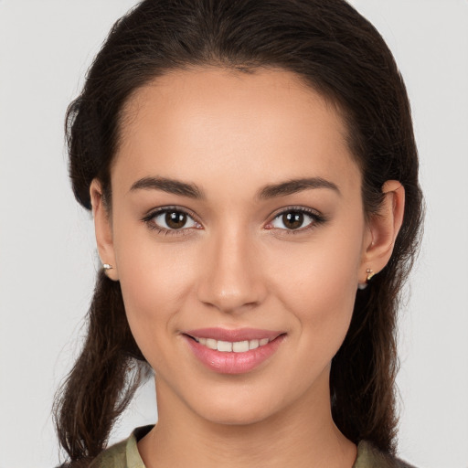 Joyful white young-adult female with long  brown hair and brown eyes