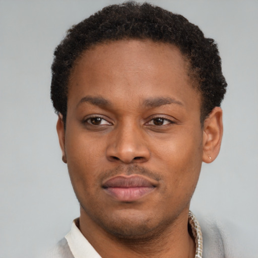 Neutral latino young-adult male with short  brown hair and brown eyes