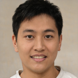 Joyful asian young-adult male with short  brown hair and brown eyes