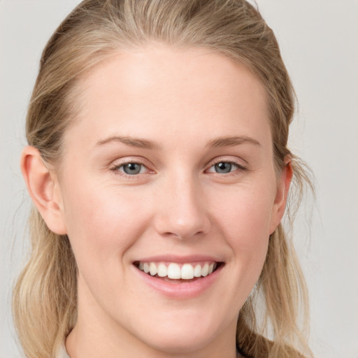 Joyful white young-adult female with long  brown hair and blue eyes