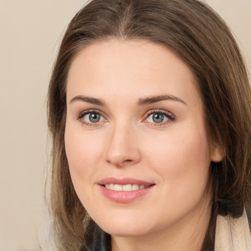 Joyful white young-adult female with long  brown hair and grey eyes