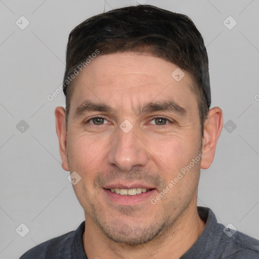 Joyful white adult male with short  brown hair and grey eyes