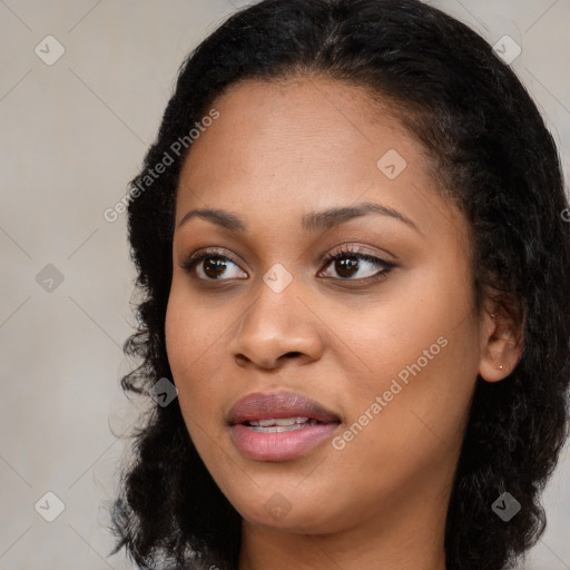 Joyful black young-adult female with long  brown hair and brown eyes