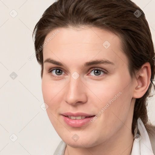 Joyful white young-adult female with medium  brown hair and grey eyes