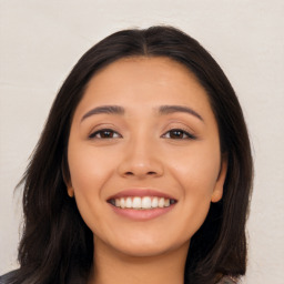 Joyful latino young-adult female with long  brown hair and brown eyes