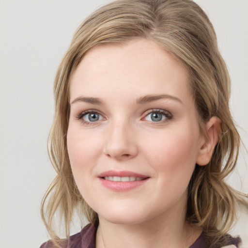 Joyful white young-adult female with medium  brown hair and blue eyes