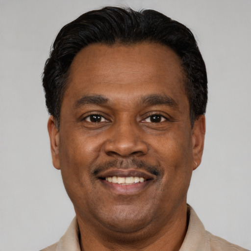 Joyful latino adult male with short  black hair and brown eyes