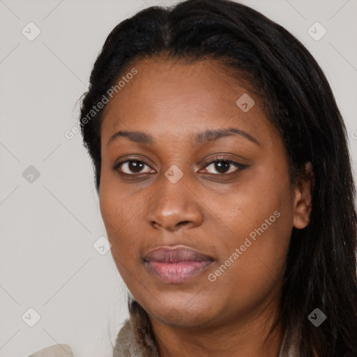 Joyful black young-adult female with long  brown hair and brown eyes