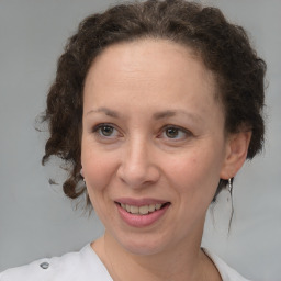 Joyful white adult female with medium  brown hair and grey eyes