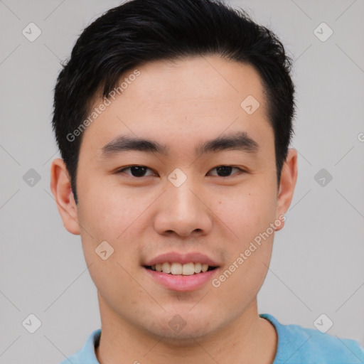 Joyful asian young-adult male with short  brown hair and brown eyes