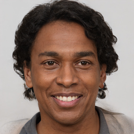 Joyful latino adult male with short  brown hair and brown eyes