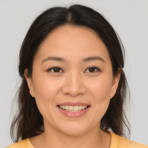 Joyful white young-adult female with medium  brown hair and brown eyes