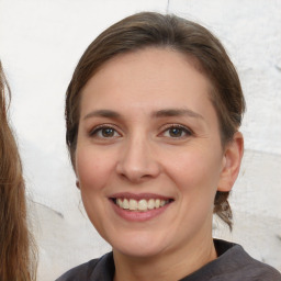 Joyful white young-adult female with medium  brown hair and brown eyes