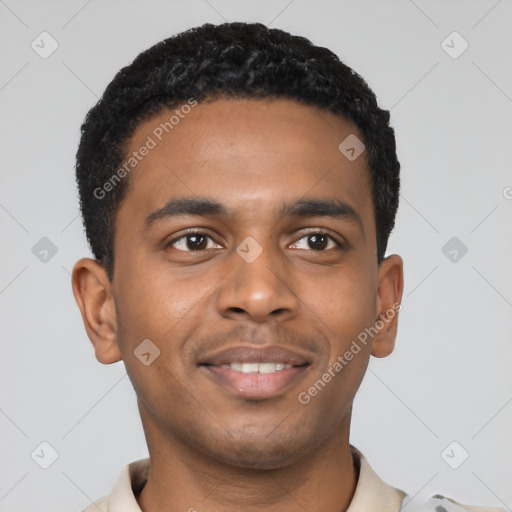 Joyful black young-adult male with short  black hair and brown eyes
