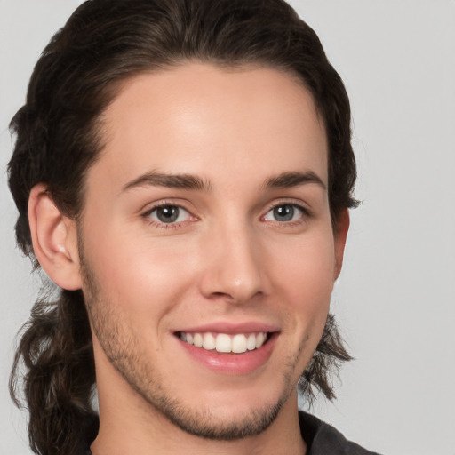 Joyful white young-adult male with medium  brown hair and brown eyes