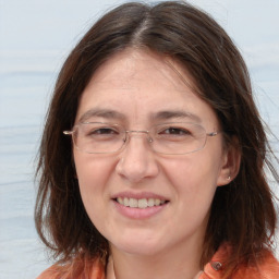 Joyful white adult female with long  brown hair and brown eyes