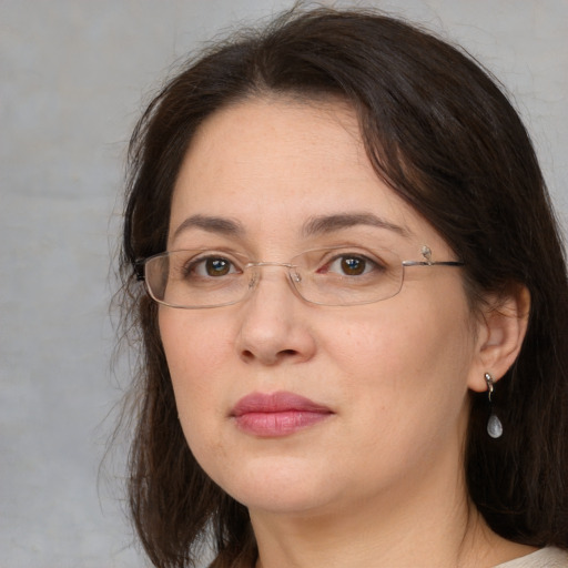 Joyful white adult female with medium  brown hair and grey eyes