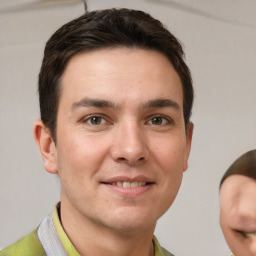 Joyful white young-adult male with short  brown hair and grey eyes