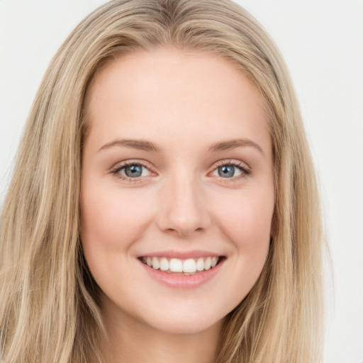 Joyful white young-adult female with long  brown hair and blue eyes