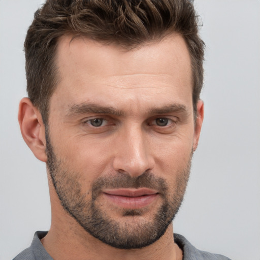 Joyful white adult male with short  brown hair and brown eyes