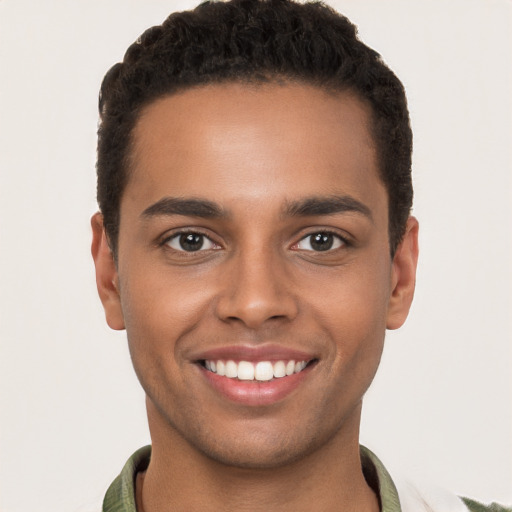 Joyful black young-adult male with short  brown hair and brown eyes