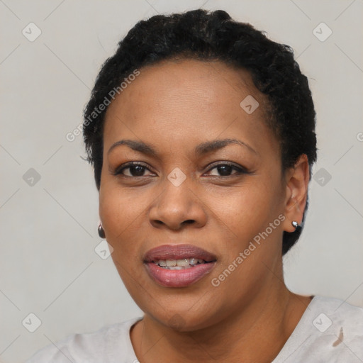 Joyful black adult female with short  black hair and brown eyes