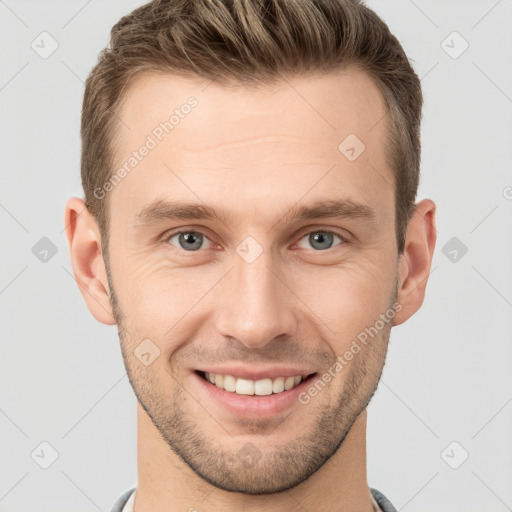 Joyful white young-adult male with short  brown hair and grey eyes