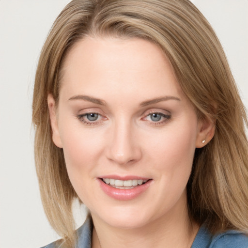 Joyful white young-adult female with long  brown hair and blue eyes