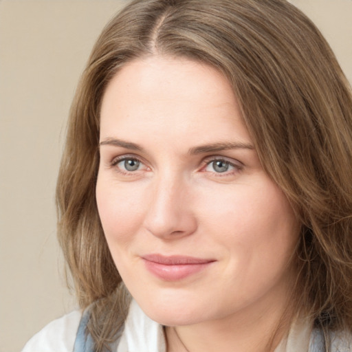 Joyful white young-adult female with medium  brown hair and green eyes