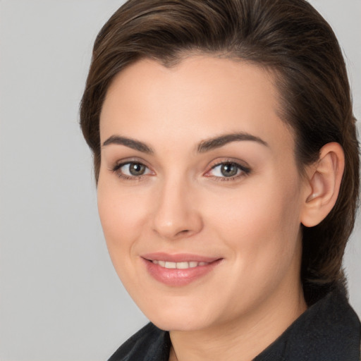 Joyful white young-adult female with medium  brown hair and brown eyes