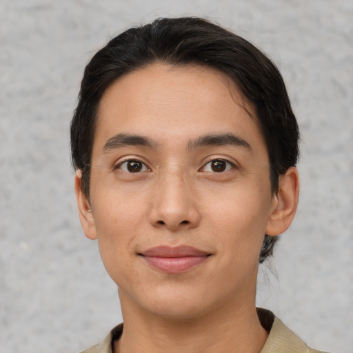 Joyful latino young-adult male with short  black hair and brown eyes