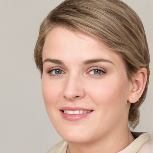 Joyful white young-adult female with medium  brown hair and green eyes