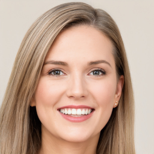 Joyful white young-adult female with long  brown hair and green eyes