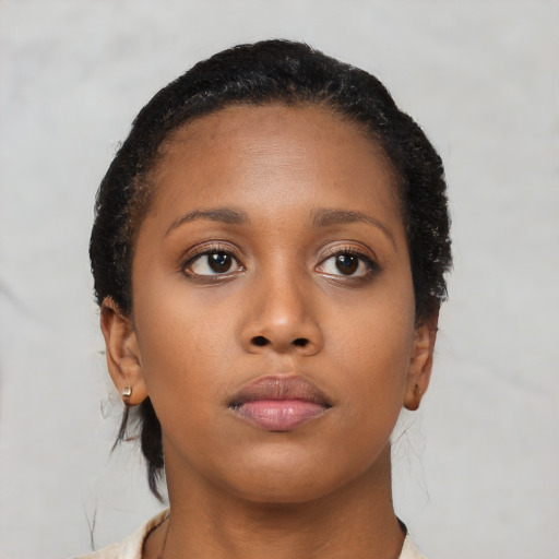 Neutral black young-adult female with medium  brown hair and brown eyes