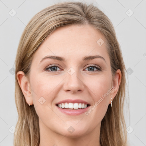 Joyful white young-adult female with long  brown hair and grey eyes