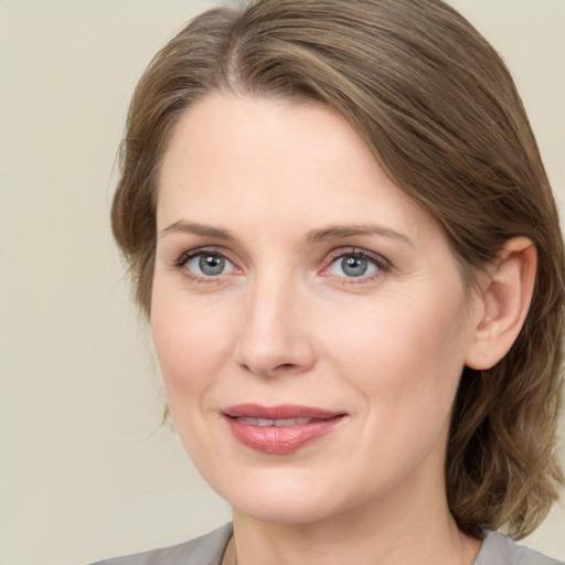 Joyful white young-adult female with medium  brown hair and blue eyes