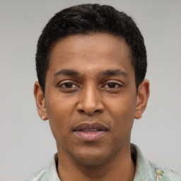 Joyful latino young-adult male with short  black hair and brown eyes