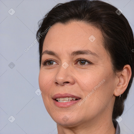 Joyful white adult female with medium  brown hair and brown eyes