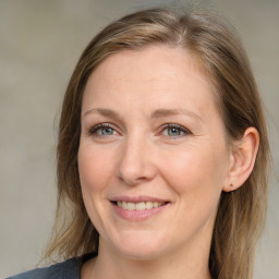 Joyful white adult female with medium  brown hair and grey eyes