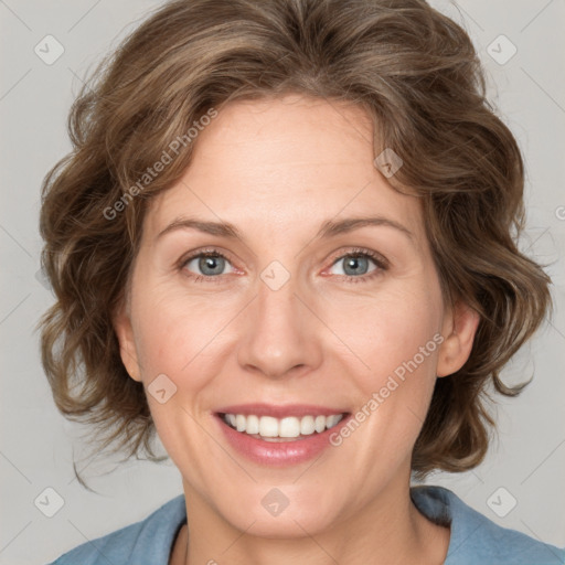 Joyful white adult female with medium  brown hair and blue eyes