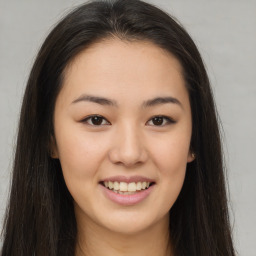 Joyful latino young-adult female with long  brown hair and brown eyes