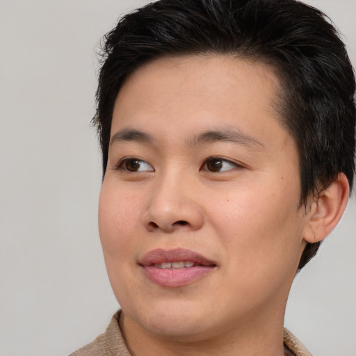 Joyful asian young-adult male with short  brown hair and brown eyes