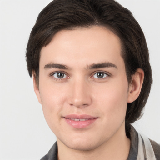 Joyful white young-adult male with medium  brown hair and brown eyes