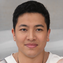 Joyful asian young-adult male with short  brown hair and brown eyes