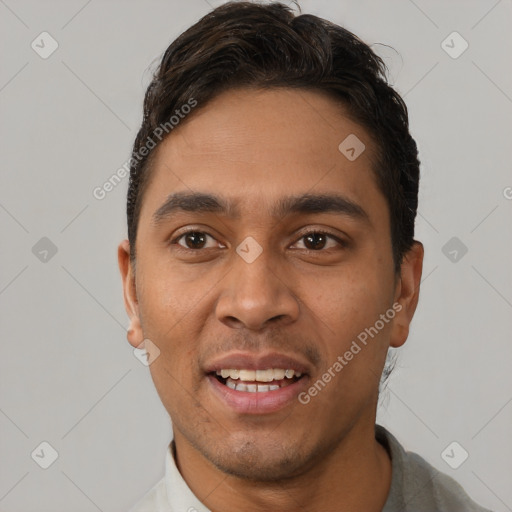 Joyful white young-adult male with short  black hair and brown eyes